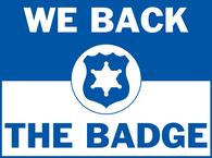 A blue and white "We Back The Badge" graphic.