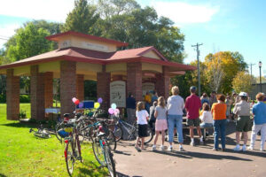 A group of community members gathered around the West Salem, Wisconsin Bike Shelter.